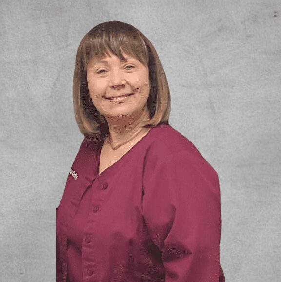 Woman staff in maroon clinic jacket