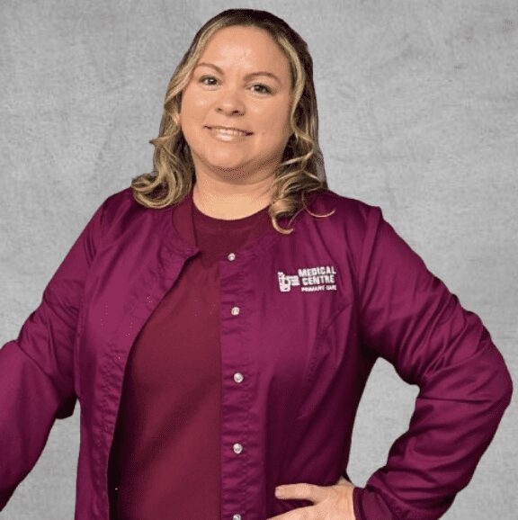 Female clinic staff wearing maroon jacket