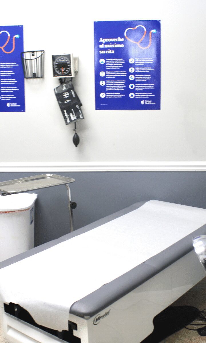 Empty medical exam table with wall monitor